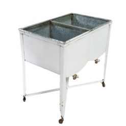 Vintage washing system with two tubs. White on the outside and silver metal inside. On wheels.