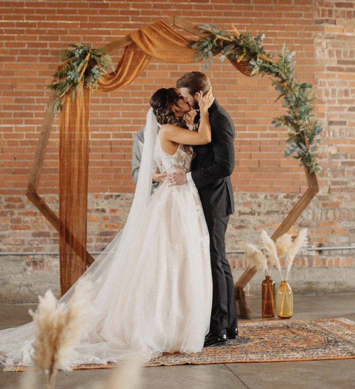 Wooden hexagonal backdrop decorated with florals and colorful linen