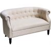Off white loveseat with tufted button back, 1 cushion seat, and brown wooden legs