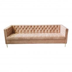 Modern pale pink velvet sofa with hard edges and tufted seat and back