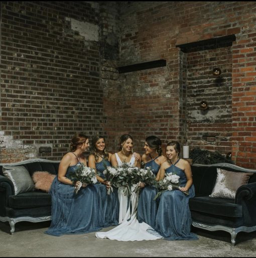 Navy blue sectional with bride and 4 bridesmaids seated