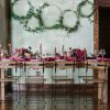 Wooden and metal Ceil folding chairs at a long farm table with decor.