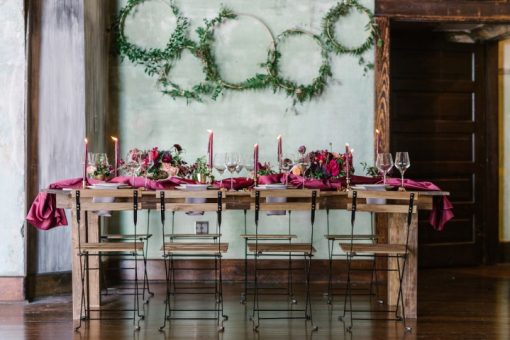 Wooden and metal Ceil folding chairs at a long farm table with decor.