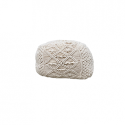 Ivory macrame pouf with geometric designs.