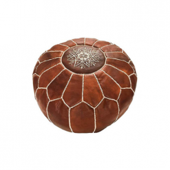Brown leather Moroccan style pouf with white stitching creating geometic shapes along the sides and a snowflake like design in the center of the top.