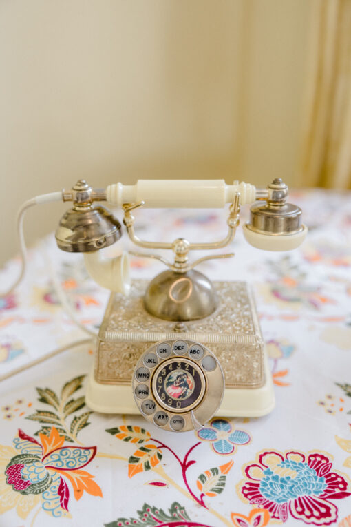 Vintage cream and gold phone with rotary dial.