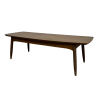 Side angle of brown rectangular coffee table with round edges. Thick lip under the top.