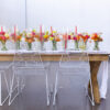 Light color farm table with white wire chairs with bright