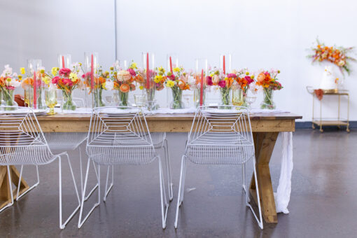 Light color farm table with white wire chairs with bright