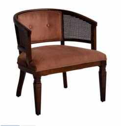 Dark dusty pink barrel chair with velvet on seat and back. Cane on arms. Dark wood edging, around cane, and legs.