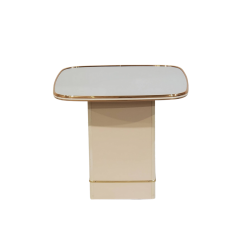 Square off white base with rounded edge square mirror top that extends past the base. Brass trim. Front view