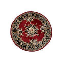 Ariel view of a round rug with navy flowered border and deep red inside. Navy and white medallion in the center.
