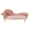 fainting sofa rental in a light pink fabric. High wave on the left flowing into a lower edge on the right. Left side has an arm for resting on. Tufted back and gold detailing.