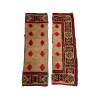 Pair of Maya boho runners. Formerly a full area rug, it has been cut into two strips. Thick border with geometric designs in yellow, green, and red. Large red diamonds in rows inside the border