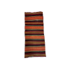 Boho runners with bold stripes in black, orange, red, yellow, and teal. Arial photo of a single runner.