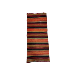 Boho runners with bold stripes in black, orange, red, yellow, and teal. Arial photo of a single runner.