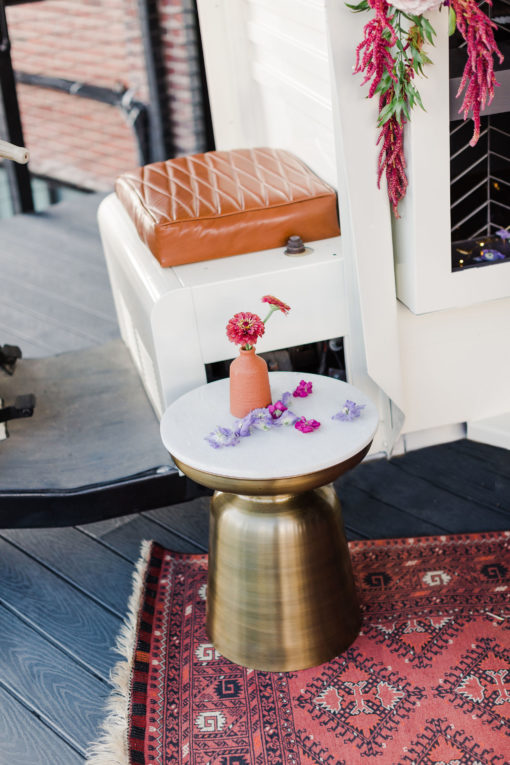 Sade Side table sitting on a rug in a styled shoot