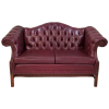 Maroon leather chesterfield sofa with tufted back, two cushions, and winged arms