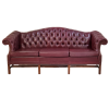 Maroon chesterfield sofa, front view. Button tufted back, wing arms, and 3 cushions.