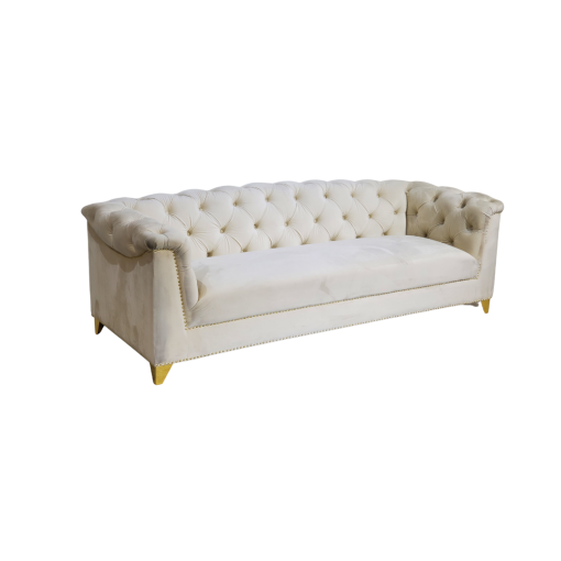 White velvet sofa, side view. Tufted back that rolls over the arms. Solid long cushion.