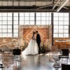 Diamond Shaped backdrop against a brick background with large industrial windows.