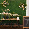 Vendor cart against a boxwood backdrop. Holding display of flowers in a bouquet bar