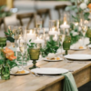 Wedding reception tablescape with farm tables, cylinder candle holders and olive mismatched goblets.