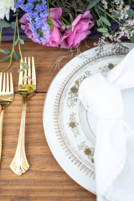 Mismatched gold china in a tablescape