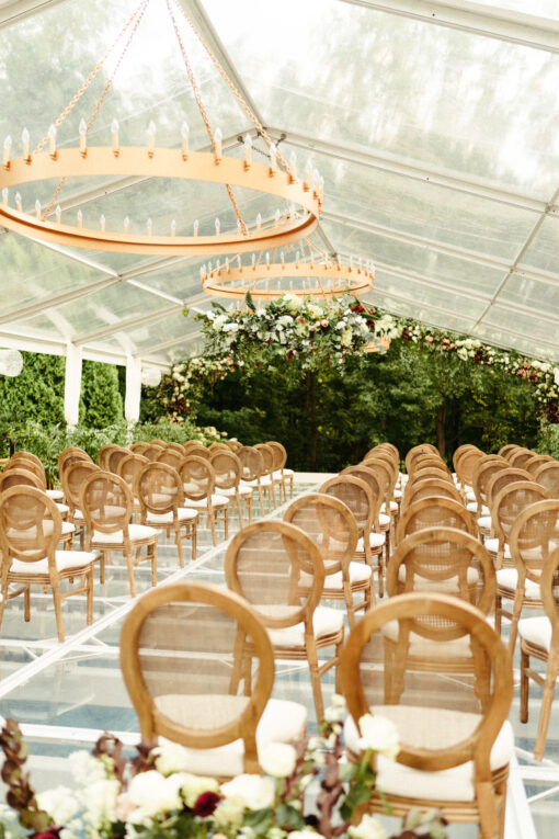 Louis cane back chairs set up for a wedding ceremony.