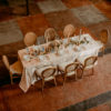 Arial view of wedding reception table with our Louis Cane Back Chair rental from Violet Vintage Rentals