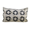 Rectangular pillow with tan background and black southwest designs. Two rows of 3