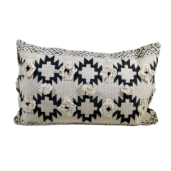 Rectangular pillow with tan background and black southwest designs. Two rows of 3