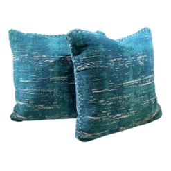 Teal square pillow with flecks of green, cream, blue.