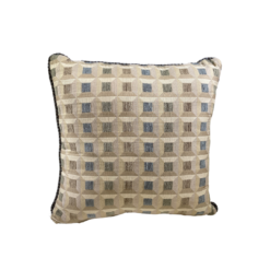 Tan square pillow with small organized squares in light blue, olive, and brown