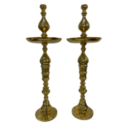 Tall gold decor shaped like a candlestick with a round plate 3/4 of the way to the top.