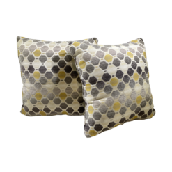 Off white pillow with yellow and gray hexagon shapes repeated
