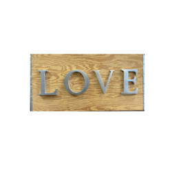 Wood with silver capital letters spelling LOVE