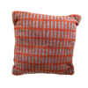 Orange square pillow with small gray rectangles in repeated pattern