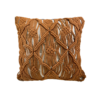 Square off white pillow with burnt orange / rust colored macrame in designs over the pillow.