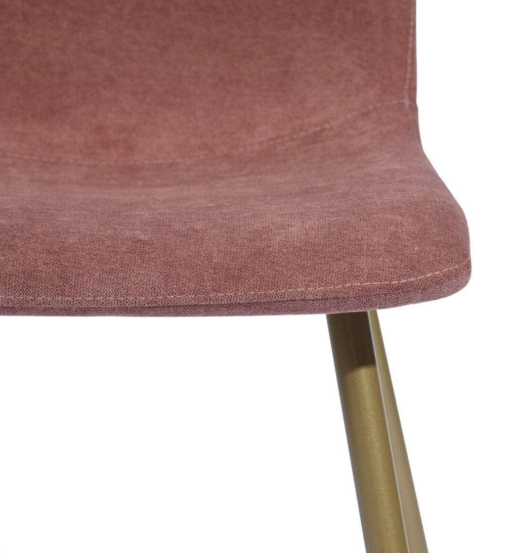 Close up of chair edge. Textured soft fabric with round edges. Gold metal legs