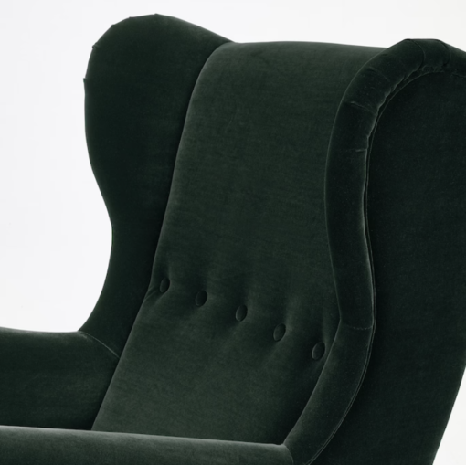 Close up of curves at top and button detailing in the middle of the back of the chair