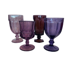 Assorted sizes, colors, and styles of purple goblets in different hues.