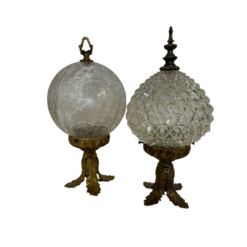 Pair of vintage decorative table top globes. Brass base with cut glass top and brass decorative top.