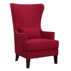 a red wing back chair with nail trim