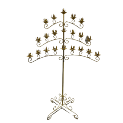 Gold floor standing candelabra with 3 wide symmetrical arms. Bottom arm has 4 spots of candles on both the right and the left side of the post, middle arm has 3 and the top arm has two.