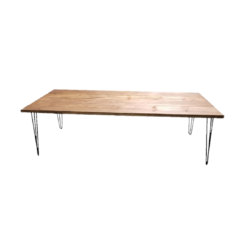 Wooden farm table with medium stain. Black metal hairpin legs on each corner.