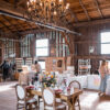 Wooden farm table with 4 french Louis chairs at a quaint barn setting.