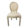 A french style chair with light wood framing and cream upholstered back and seat.