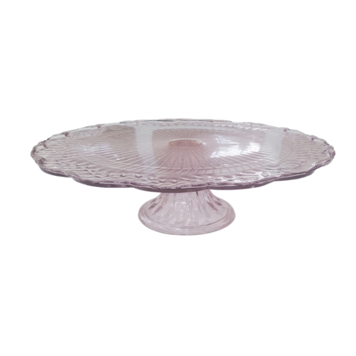 Light pink glass pedestal cake stand with scalloped edges.