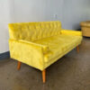 Side angle of yellow velvet sofa rental